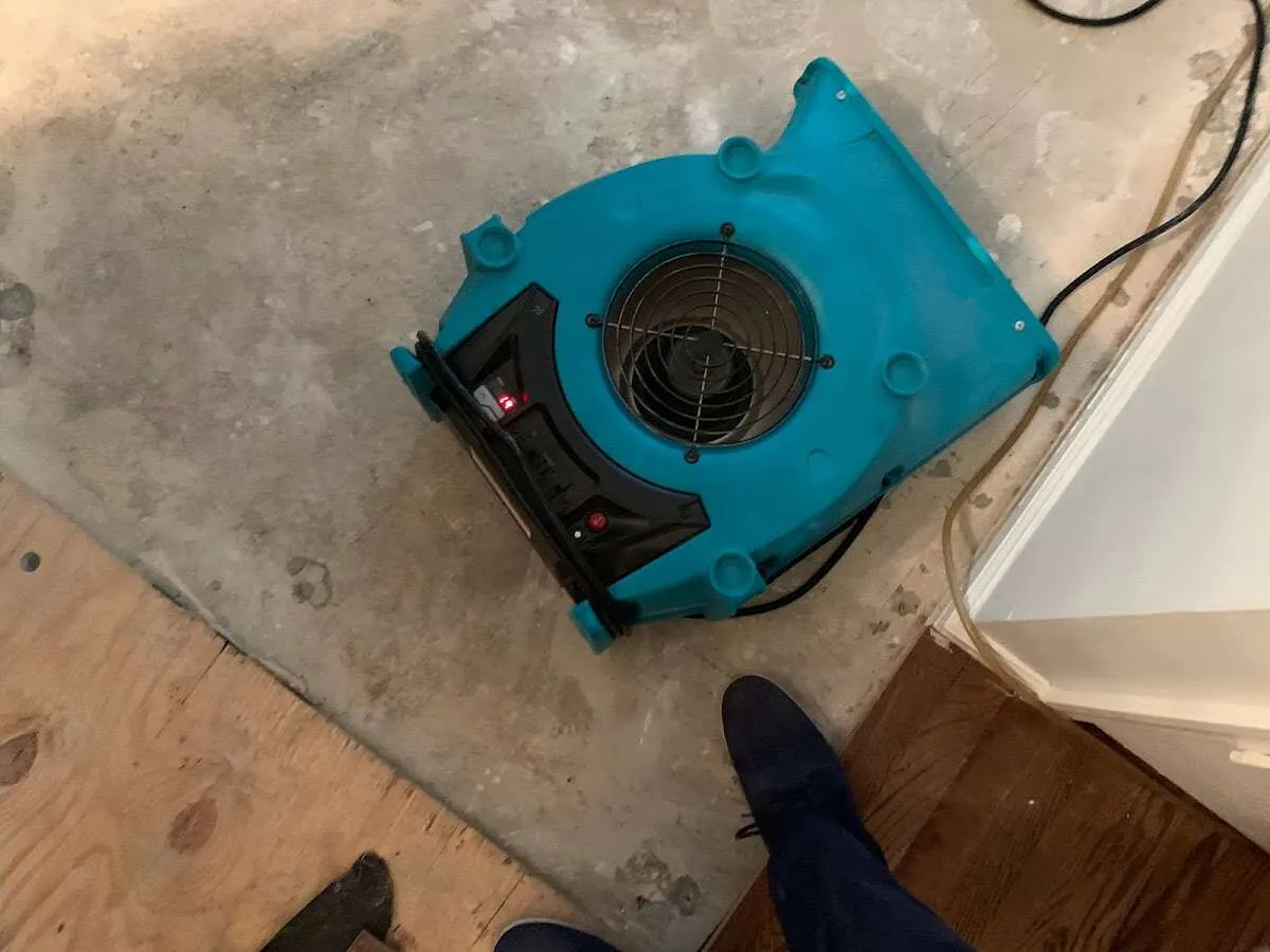 Air mover drying subfloor during Commercial Water Damage Restoration in West Hollywood